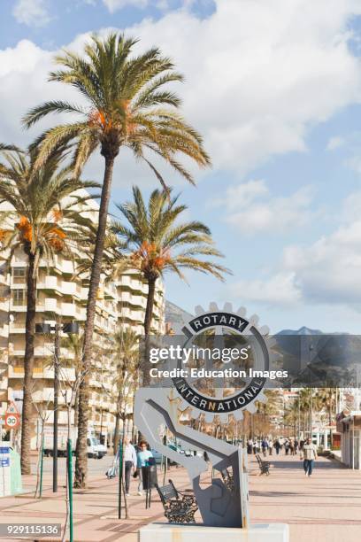 Rotary International emblem on seaside promenade, Los Boliches, Fuengirola, Malaga Province, Costa del Sol, Spain.