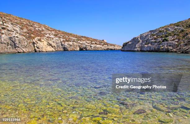 Shoreline clear blue sea water, Mgarr ix-Xini coastal inlet, island of Gozo, Malta.