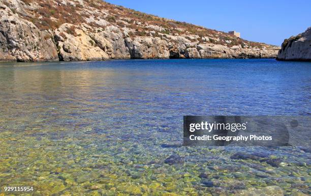 Shoreline clear blue sea water, Mgarr ix-Xini coastal inlet, island of Gozo, Malta.