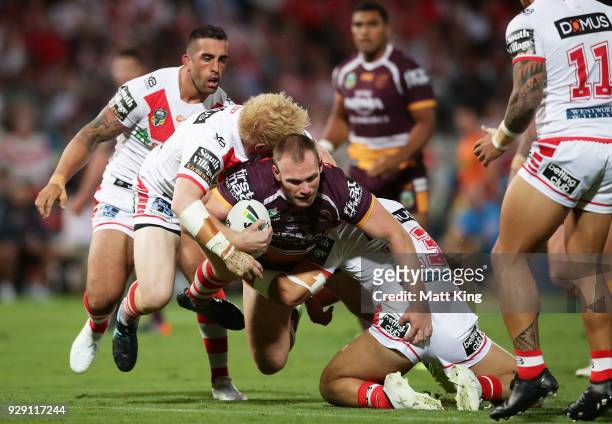 Matthew Lodge of the Broncos is tackled during the round one NRL match between the St George Illawarra Dragons and the Brisbane Broncos at UOW...
