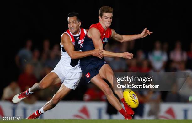 Bayley Fritsch of the Demons and Shane Savage of the Saints compete for the ball during the JLT Community Series AFL match between the Melbourne...