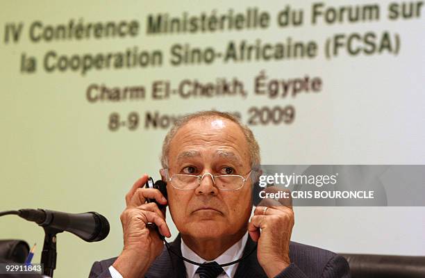 Egyptian Minister of Foreign Affairs Ahmed Abul Gheit adjusts his headphones while holding a joint press conference with his Chinese counterpart Yang...