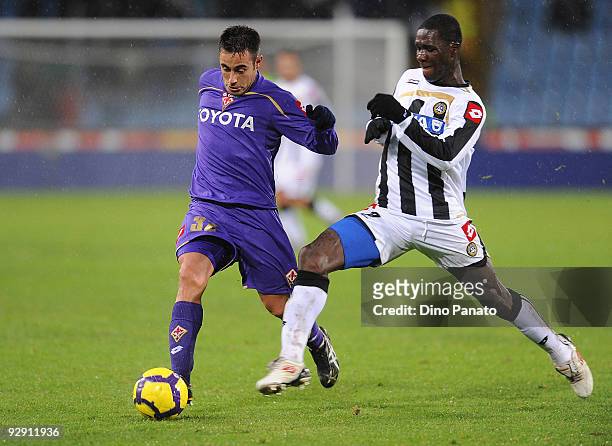 Cristian Edoardo Zapata Valencia of Udinese Calcio competes with Marco Marchionni of ACF Fiorentina during the Serie A match between Udinese Calcio...