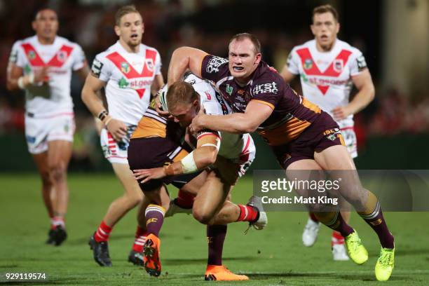 Jack De Belin of the Dragons is tackled by Matthew Lodge of the Broncos during the round one NRL match between the St George Illawarra Dragons and...
