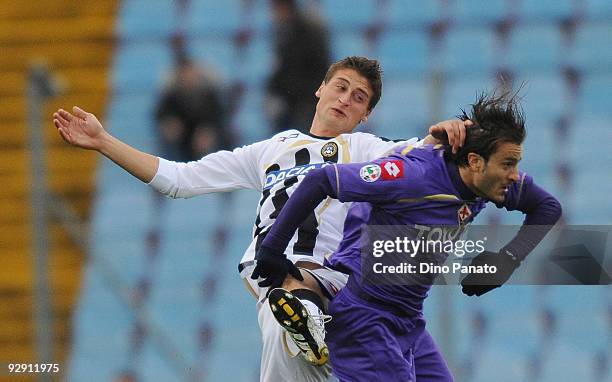 Andrea Coda of Udinese Calcio competes in the air with Alberto Gilardino of ACF Fiorentina during the Serie A match between Udinese Calcio and ACF...