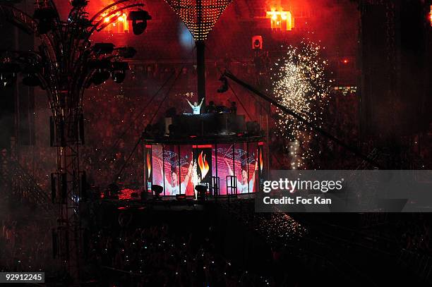 On a tower above giant screens DJ David Guetta performs at the Cathy Guetta Presents 'Unighted' - DJ Show at the Stade de France on July 4, 2009 in...