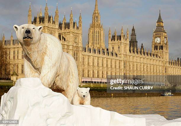 Life-like 16ft high sculpture of an iceberg featuring a stranded polar bear and its cub is pictured on the River Thames in London, on January 26,...