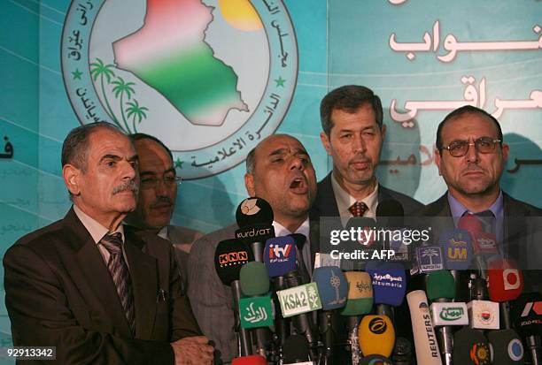 Shiite Muslim Turkmen MP Abbas al-Bayati speaks to the press as other Turkmen MPs listen on following an Iraqi Parliament session in which a law to...