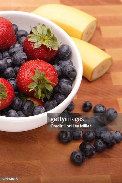 fresh fruit on cutting board - lori lee stockfoto's en -beelden