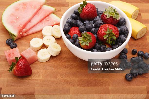 fresh fruit on cutting board - lori lee stockfoto's en -beelden