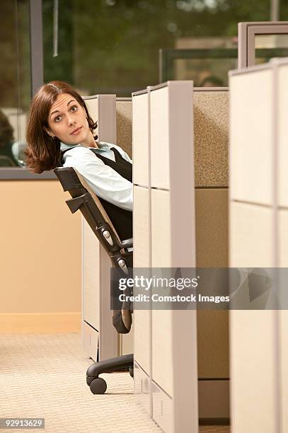 woman leaning back in chair in cubicle - bending over backwards stock pictures, royalty-free photos & images
