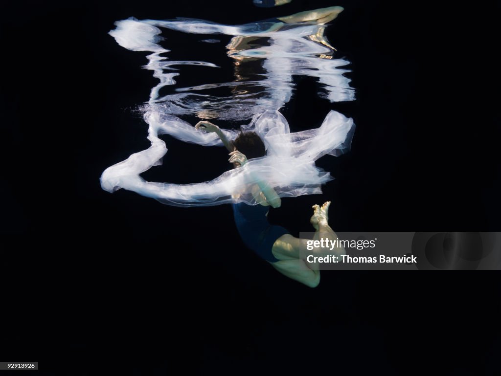 One String Falling Ballerina Falling Through Fabric Underwater High-Res Stock Photo ...
