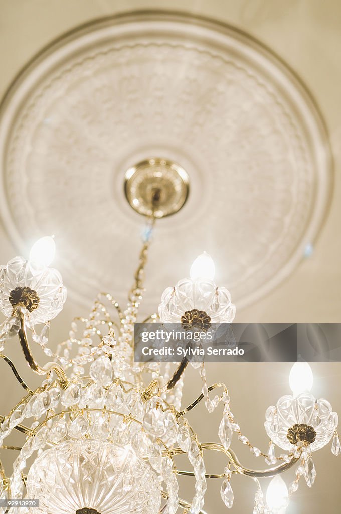 Elegant crystal chandelier hanging from ceiling