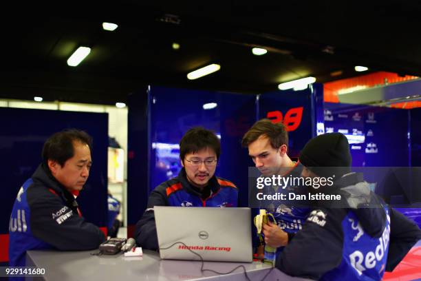 Pierre Gasly of France and Scuderia Toro Rosso talks with Honda employees in the garage during day three of F1 Winter Testing at Circuit de Catalunya...