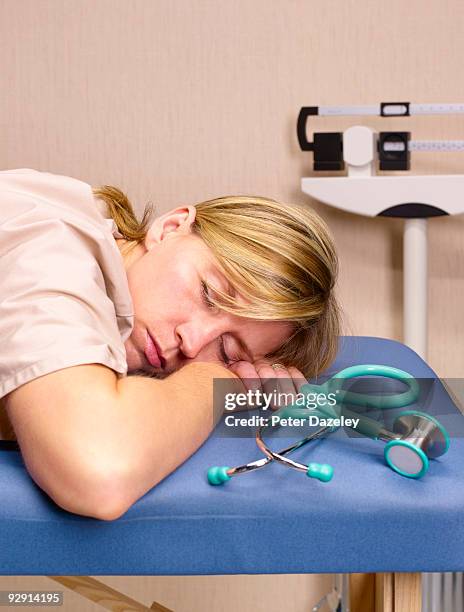 over worked female doctor resting. - parsons green stockfoto's en -beelden