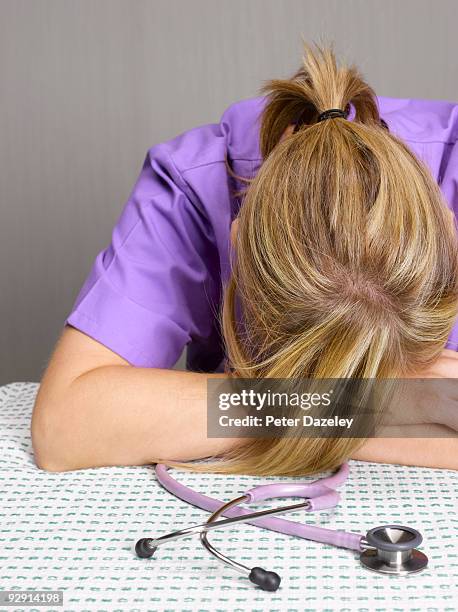 female overworked doctor sleeping. - parsons green stock pictures, royalty-free photos & images