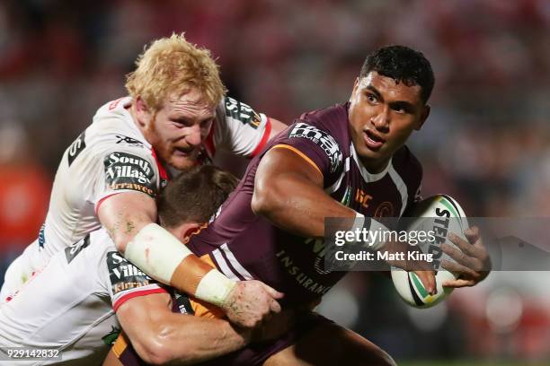 Tevita Pangai of the Broncos is tackled by James Graham of the Dragons during the round one NRL match between the St George Illawarra Dragons and the...