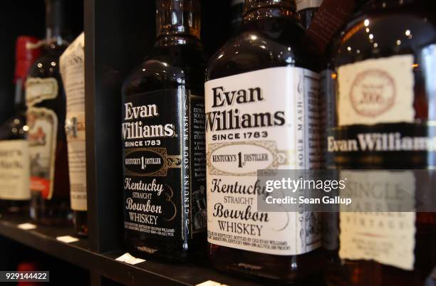 Bottles of American bourbon whiskey stand on display at a whiskey shop on March 8, 2018 in Berlin, Germany. U.S. President Donald Trump has promised...