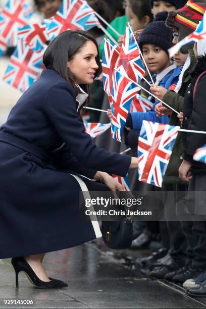 Meghan Markle talks to children as she arrives to Birmingham on March 8, 2018 in Birmingham, England.