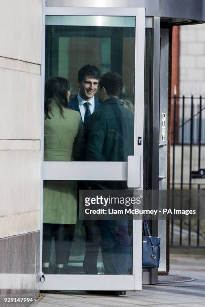 Blane McIlroy interacts with Ireland and Ulster rugby player Paddy Jackson as they meet while queuing to enter Belfast Crown Court, where Mr McIlroy...