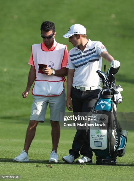 Emiliano Grillo of Argentina and caddie Chris Rice look on from the 15th hole during day one of the Hero Indian Open at Dlf Golf and Country Club on...