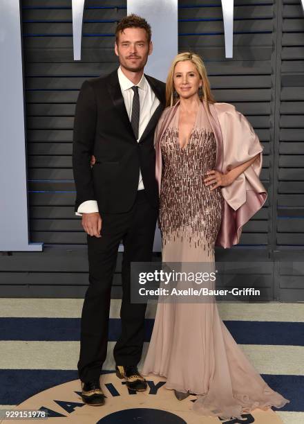 Actors Christopher Backus and Mira Sorvino attend the 2018 Vanity Fair Oscar Party hosted by Radhika Jones at Wallis Annenberg Center for the...