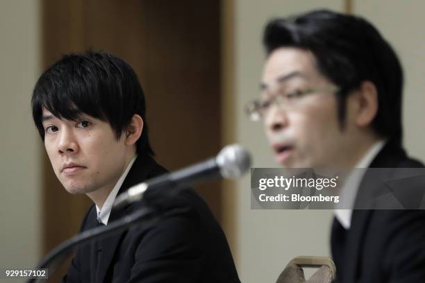 Koichiro Wada, president of Coincheck Inc., left, looks on as Yusuke Otsuka, chief operating officer of Coincheck Inc., speaks during a news...