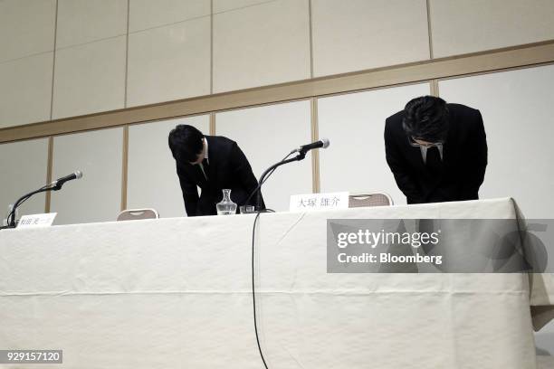 Koichiro Wada, president of Coincheck Inc., left, and Yusuke Otsuka, chief operating officer of Coincheck Inc., bow during a news conference in...