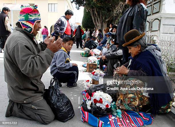 The 'Yatiri' a aymara priest prays to a old Indian skull during the Fiesta Natitas at cemetery on November 8, 2009 in La Paz, Bolivia. Bolivia...