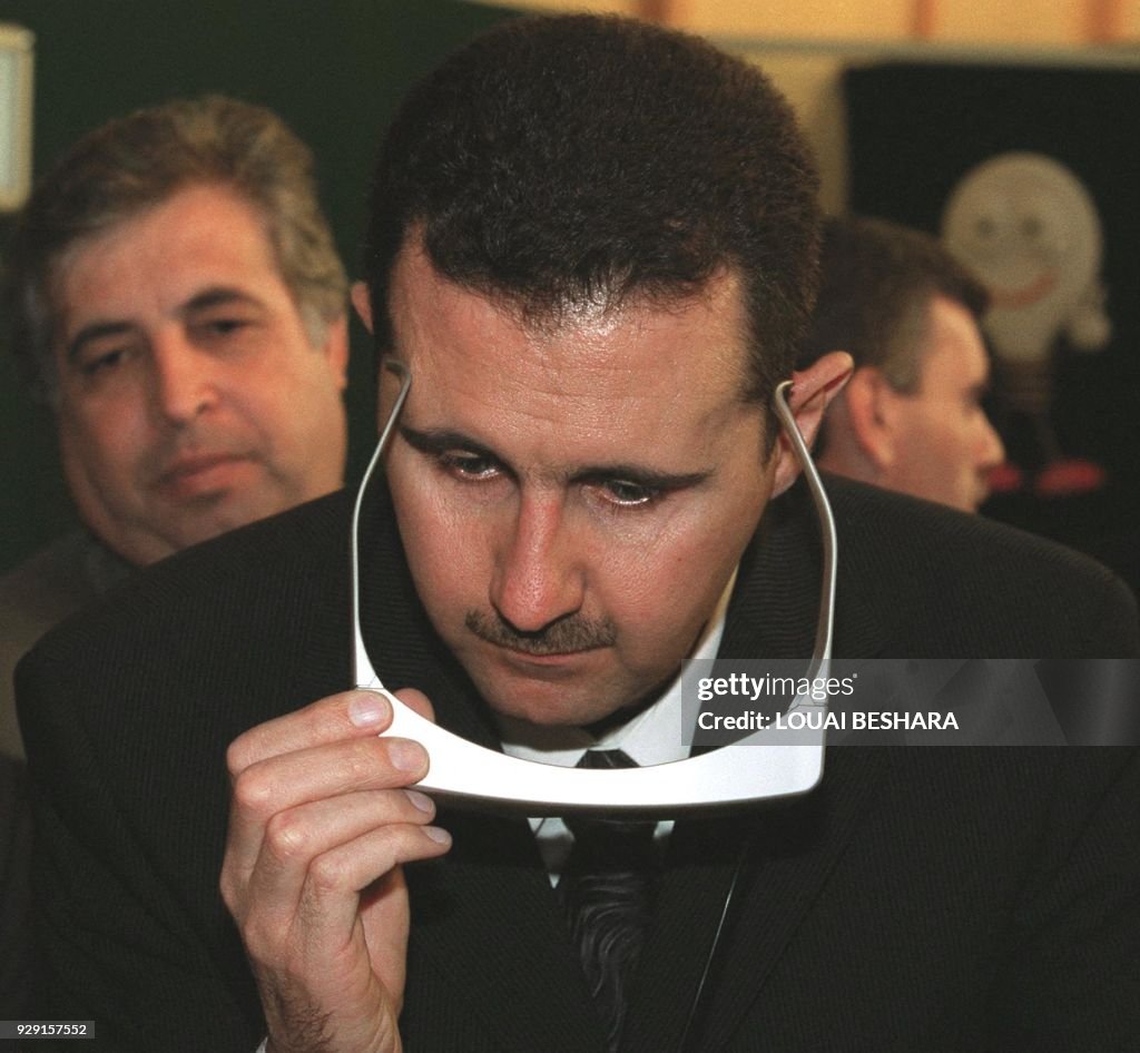 Hafz R Bashar al-Assad, son of Syrian President Hafez al-Assad, tries on a ...