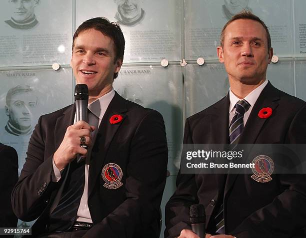 Luc Robitaille and Steve Yzerman speak with the media at the Hockey Hall of Fame Induction Photo Opportunity at the Hockey Hall of Fame on November...