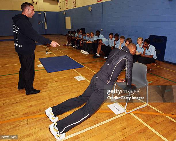 Colin Jackson OBE demonstrates some exercises in a Get Active workout at Morpeth School during the Launch of National School Meal Week on November 9,...