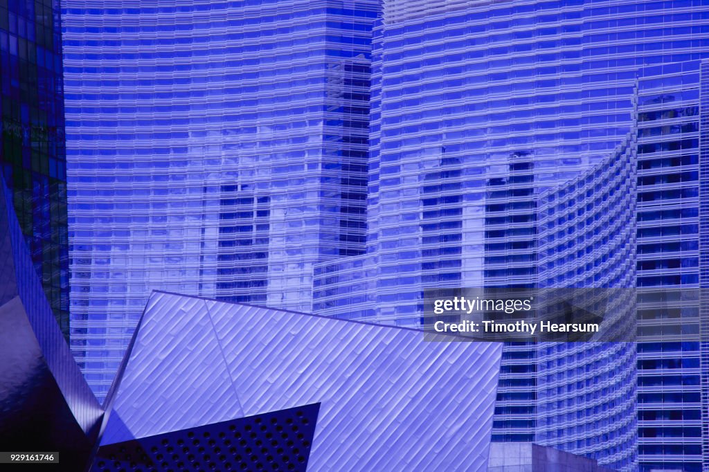 Close-up view of city skyscraper with details and reflections of nearby buildings