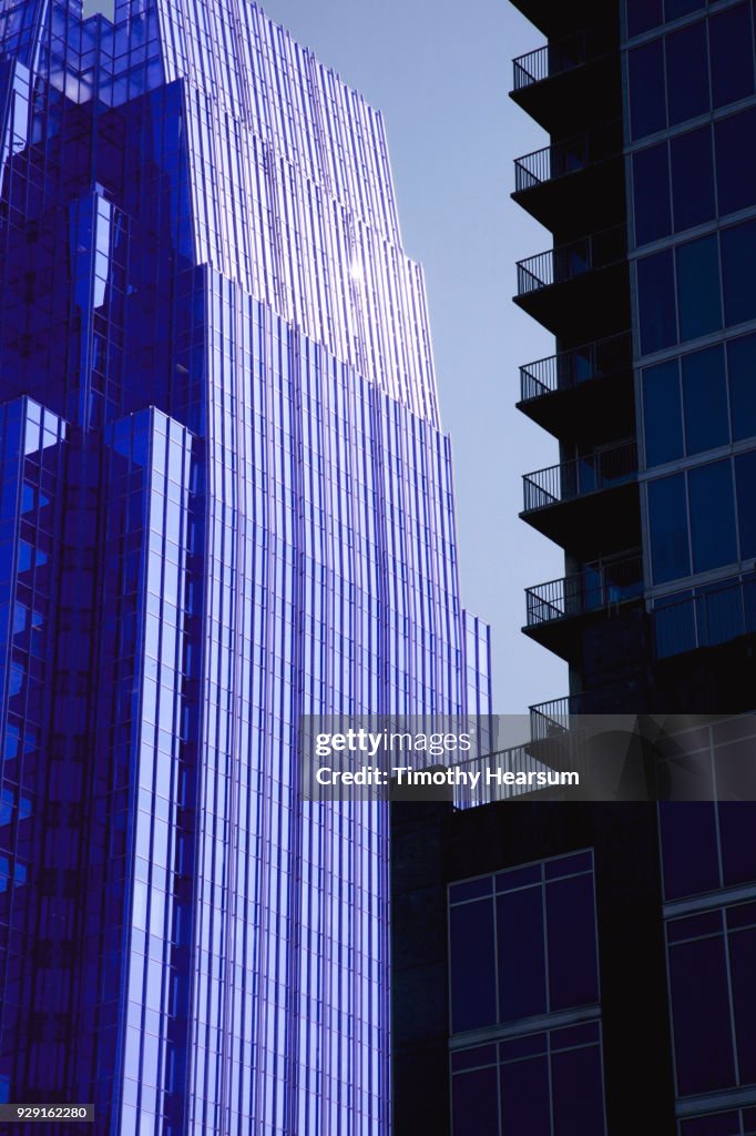 Detail view of two city skyscrapers with blue sky between