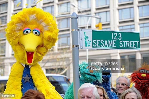 Big Bird and other Sesame Street puppet charactors pose next to temporarty street sign November 9, 2009 at West 64th Street and Broadway in New York...