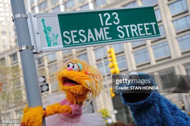 Sesame Street puppet charactors Zoe and Cookie Monster pose next to temporarty street sign November 9, 2009 at West 64th Street and Broadway in New...