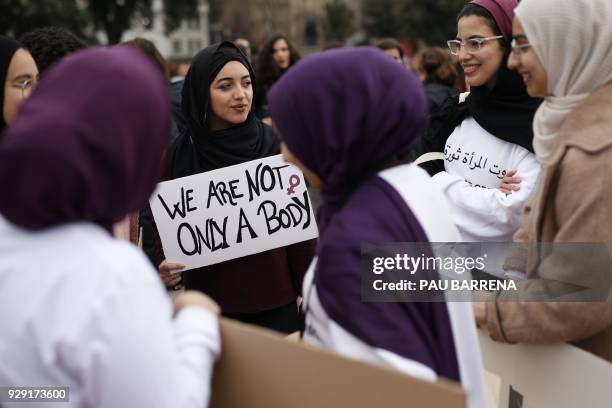 Group of women sporting hiyab hold placards as they protest during a one day strike to defend women's rights on International Women's Day in...