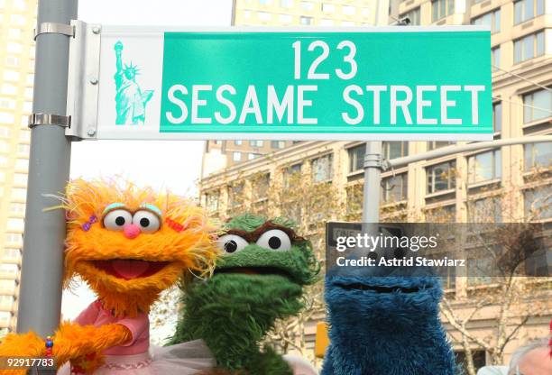 Sesame Street characters pose under a "123 Sesame Street" sign at the "Sesame Street" 40th Anniversary temporary street renaming in Dante Park on...