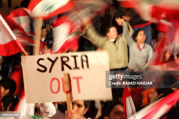 Young Lebanese demonstrators wave national flags and banners 04 March 2005 calling for Syrian army withdrawal during an open-ended protest in...