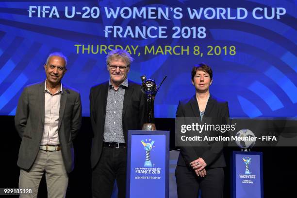 Haiti Head Coach Marc Collat, China Head Coach Peter Bond and Germany Head Coach Maren Meinert pose with the Trophy during the official draw for the...