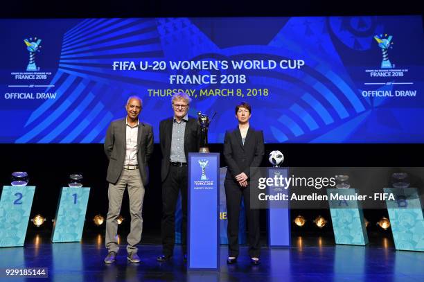 Haiti Head Coach Marc Collat, China Head Coach Peter Bond and Germany Head Coach Maren Meinert pose with the Trophy during the official draw for the...