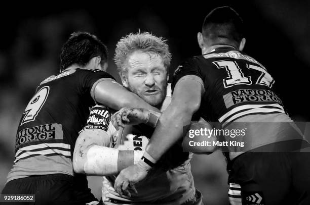 James Graham of the Dragons is tackled during the round one NRL match between the St George Illawarra Dragons and the Brisbane Broncos at UOW Jubilee...