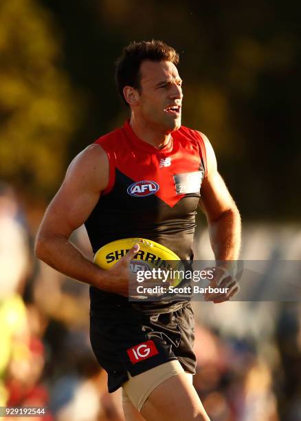 Cameron Pedersen of the Demons runs with the ball during the JLT Community Series AFL match between the Melbourne Demons and the St Kilda Saints at...