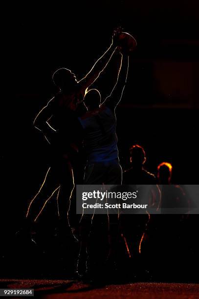 Max Gawn of the Demons and Tom Hickey of the Saints compete for the ball as the sun sets during the JLT Community Series AFL match between the...