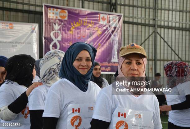 Iraqi women take part in a symbolic 900-metres marathon to mark Women's Day in the former embattled city of Mosul on March 8, 2018 eight months after...