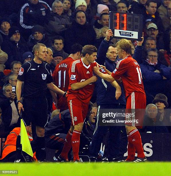 Dirk Kuyt of Liverpool helps Steven Gerrard put his captain's armband on as he is brought on for the injured Albert Riera during the Barclays Premier...