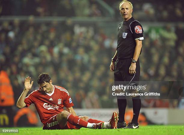 Albert Riera of Liverpool gestures after sustaining an injury during the Barclays Premier League match between Liverpool and Birmingham City at...