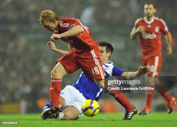 Scott Dann of Birmingham City tackles Dirk Kuyt of Liverpool during the Barclays Premier League match between Liverpool and Birmingham City at...