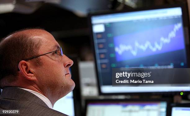 Trader works on the floor of the New York Stock Exchange before the closing bell November 9, 2009 in New York City. The Dow Jones Industrial Average...