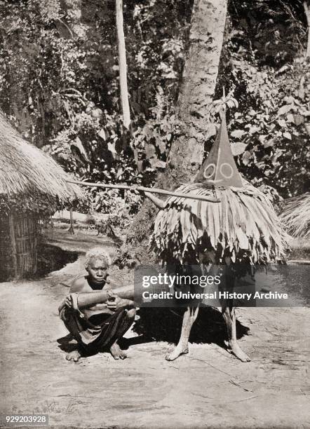 Masked dancer of a Duk-Duk secret society. The Duk-Duk was embedded in the beliefs of the Tolai peoples in the Rabaul area of New Britain, the...